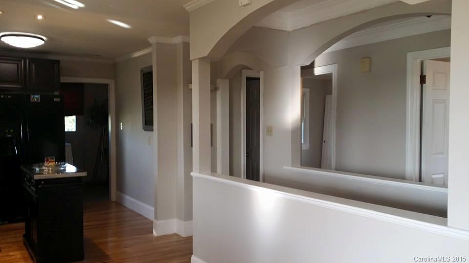 10060 Unity Church Road Mooresville, NC 28115 - Photo 8 of 22 a view of a hallway with wooden floor and a living room