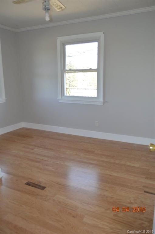 10060 Unity Church Road Mooresville, NC 28115 - Photo 9 of 22 a view of an empty room with wooden floor and a window