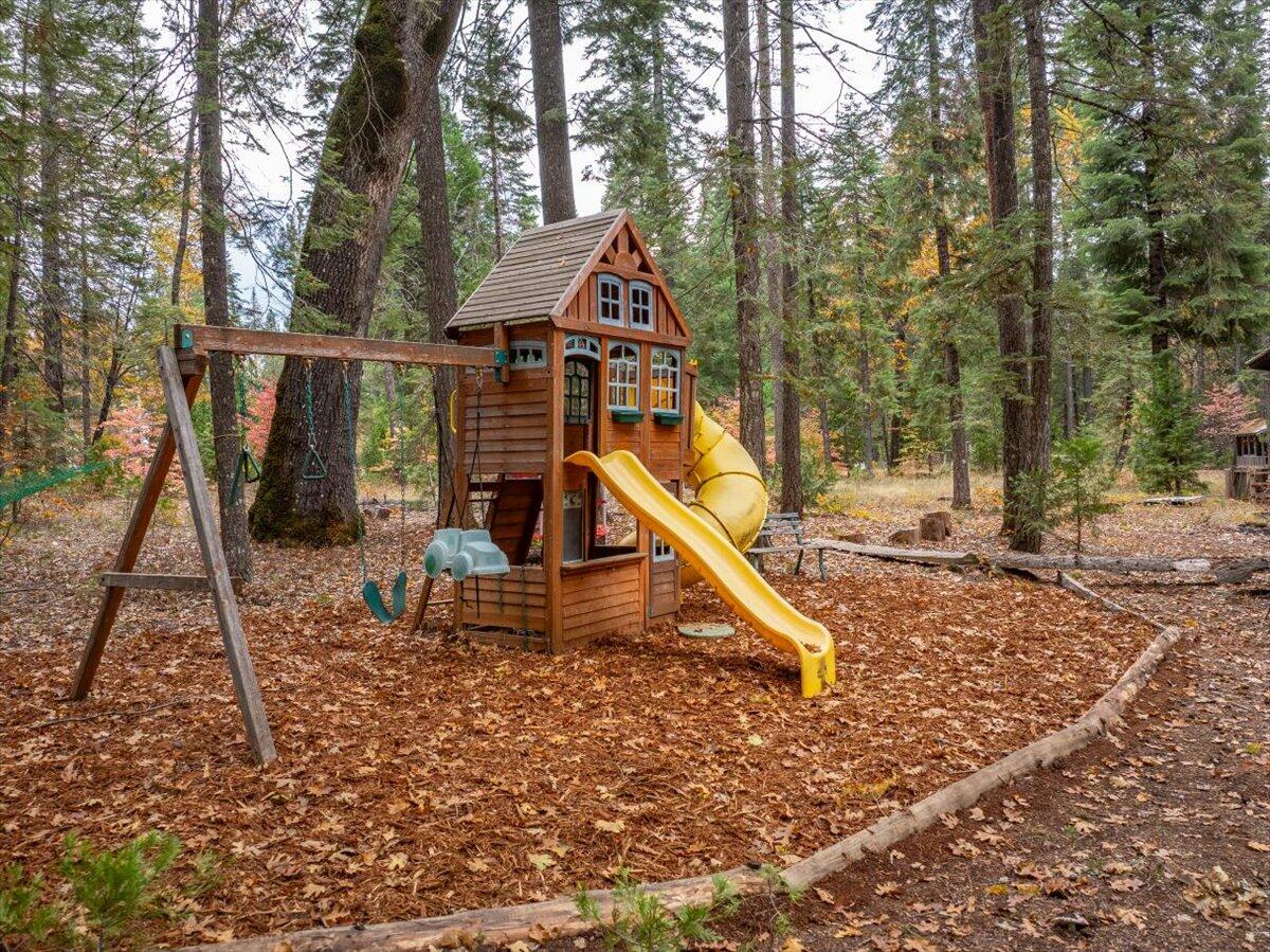 29104 Johnson Road Montgomery Creek, CA 96065 - Photo 68 of 137 a wooden bench sitting in the middle of a forest