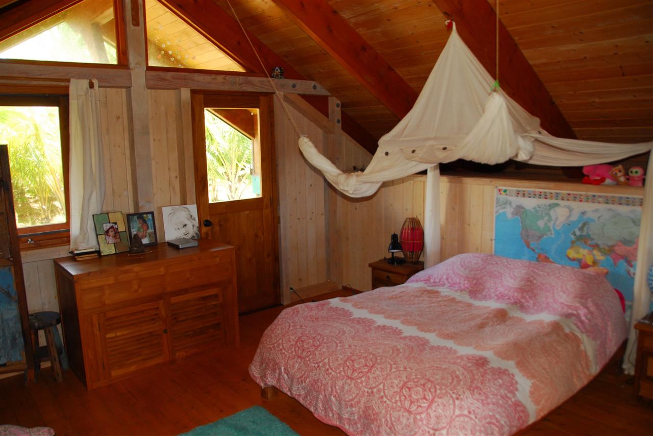 56 West Waipio Road Haiku, HI 96708 - Photo 14 of 25 a bed room with a bed mirror and a window