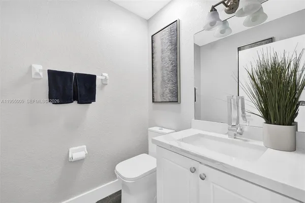 a bathroom with a sink toilet and mirror
