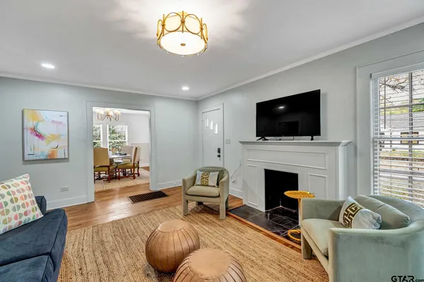 a living room with furniture fireplace and flat screen tv