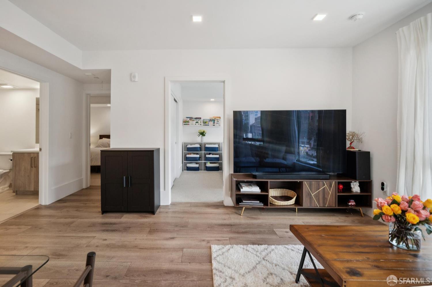 1288 Howard Street, Unit 317 San Francisco, CA 94103 - Photo 15 of 57 a living room with furniture and a flat screen tv