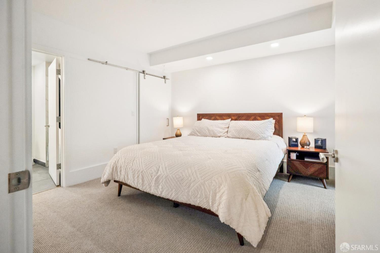 1288 Howard Street, Unit 317 San Francisco, CA 94103 - Photo 24 of 57 a bedroom with a bed and a table