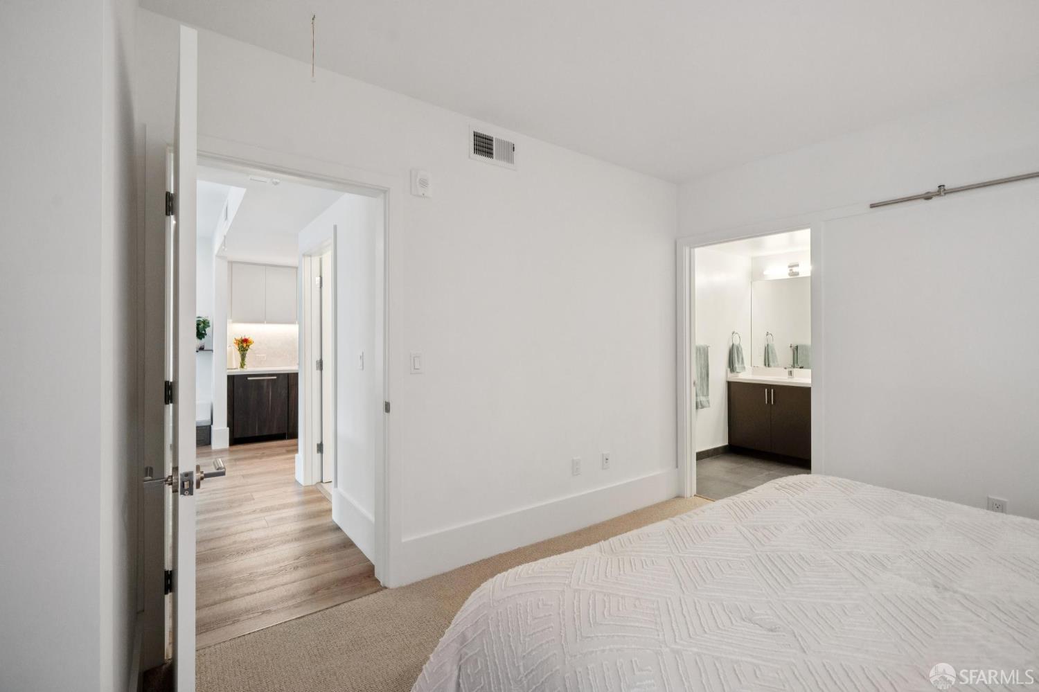 1288 Howard Street, Unit 317 San Francisco, CA 94103 - Photo 25 of 57 a bedroom with a bed and a bathroom
