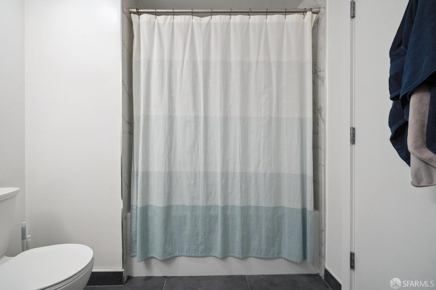 1288 Howard Street, Unit 317 San Francisco, CA 94103 - Photo 31 of 57 a bathroom with a shower curtain and sink