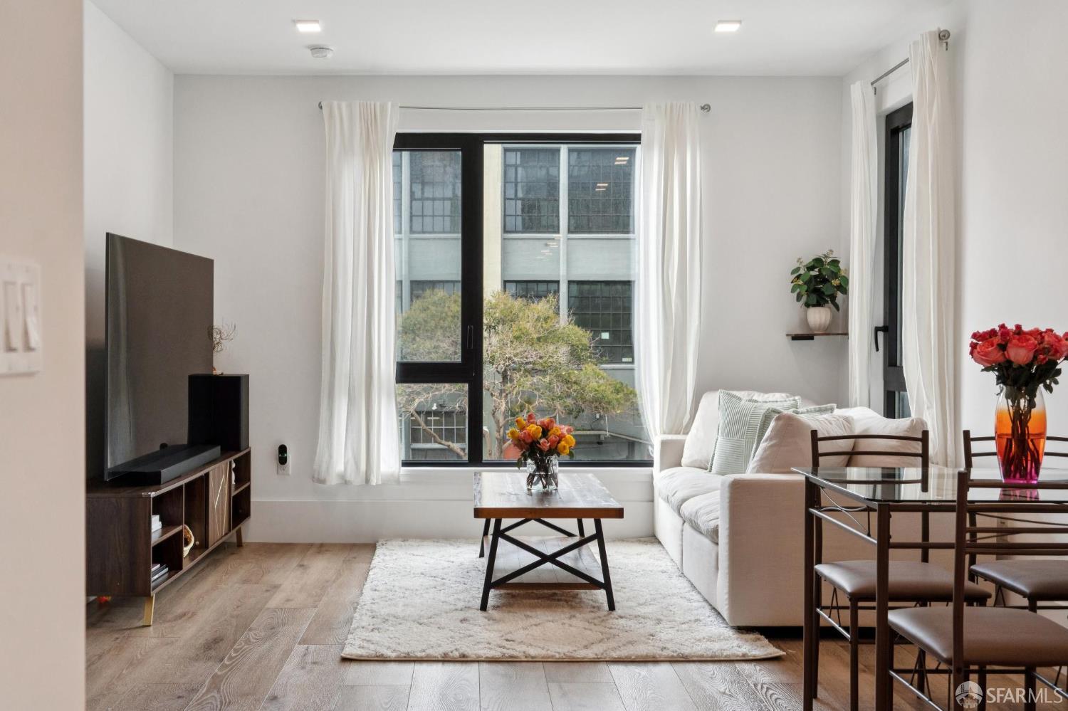 1288 Howard Street, Unit 317 San Francisco, CA 94103 - Photo 33 of 57 a living room with furniture a flat screen tv and a window