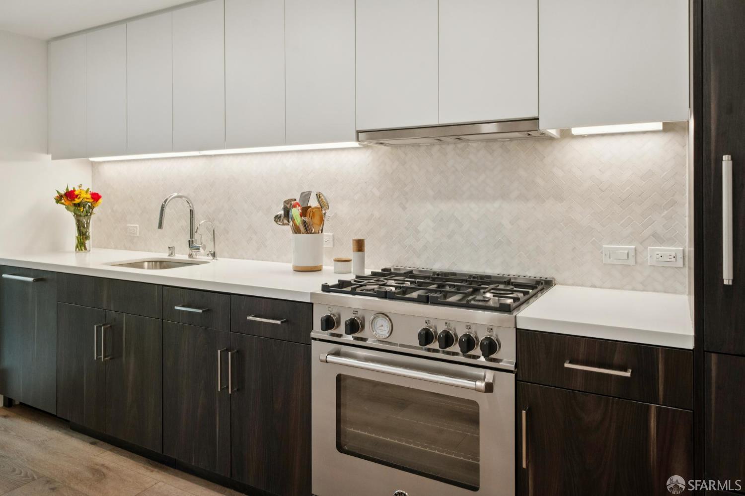1288 Howard Street, Unit 317 San Francisco, CA 94103 - Photo 10 of 57 a kitchen with a stove and a sink
