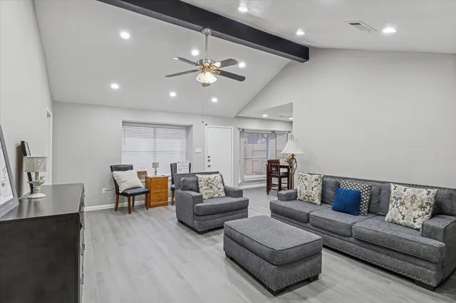 a living room with furniture and wooden floor