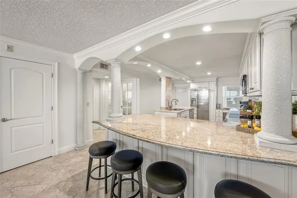 a dining room with furniture a large window and a rug