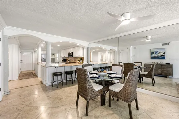 a dining room with furniture and a floor to ceiling window