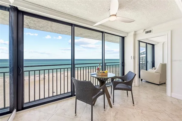 a bedroom with a bed a mirror and a lamp on dresser