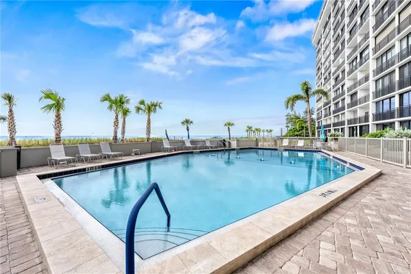 a view of a swimming pool with an outdoor seating