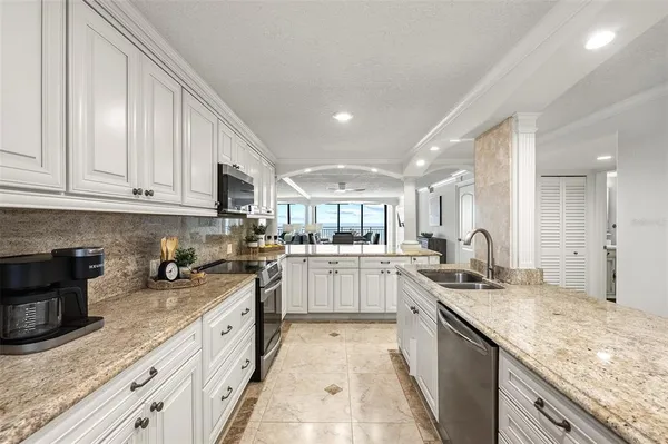 a kitchen with stainless steel appliances granite countertop a refrigerator sink and cabinets