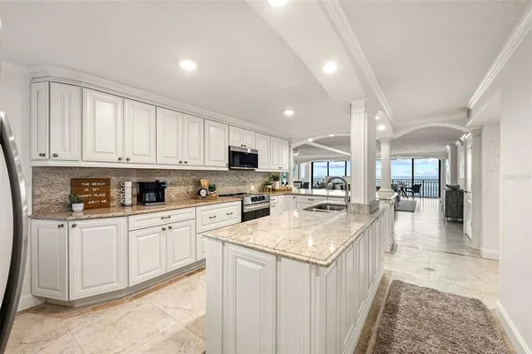 a kitchen with a sink cabinets and chairs