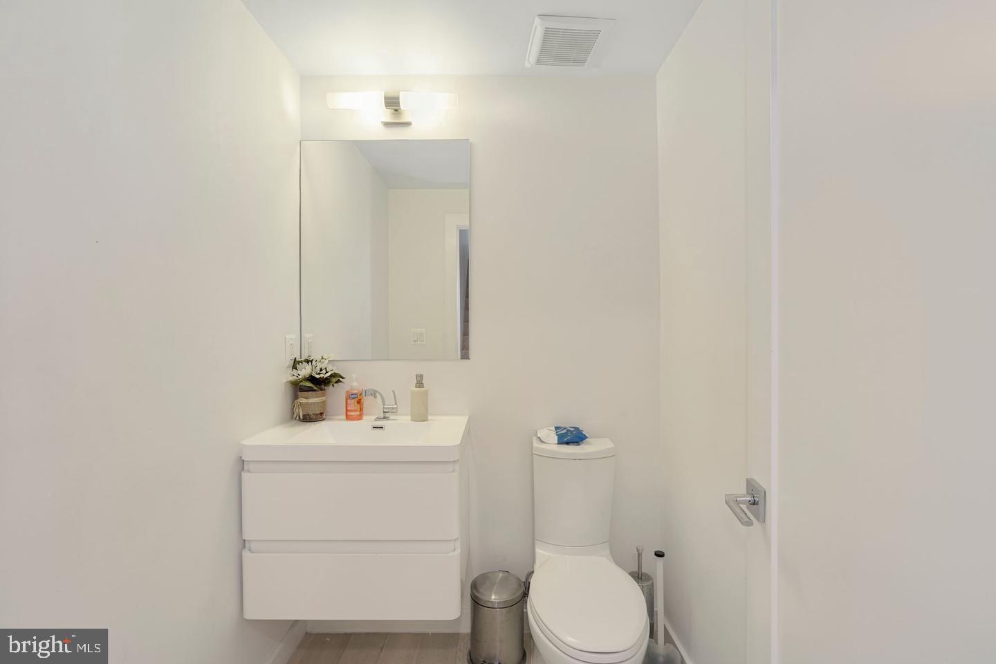 1495 Gallaudet Street Northeast Washington, DC 20002 - Photo 16 of 32 a bathroom with a sink vanity mirror and toilet