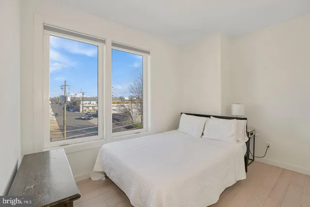 a bedroom with a large bed and a window