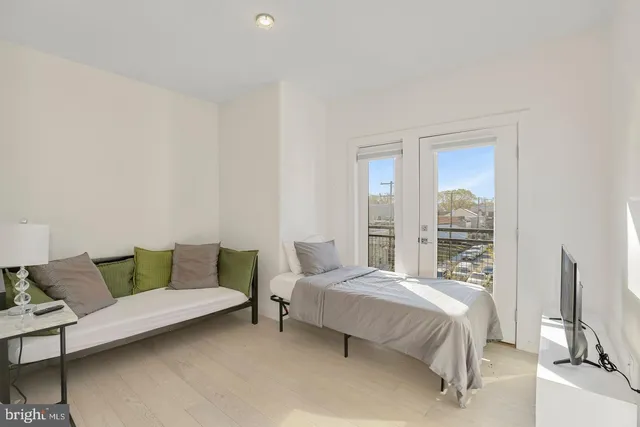 a bedroom with a bed and a couch