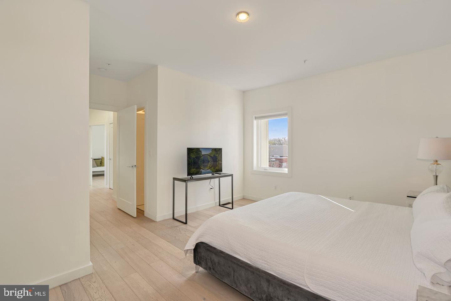 1495 Gallaudet Street Northeast Washington, DC 20002 - Photo 25 of 32 a bedroom with a bed and a flat screen tv