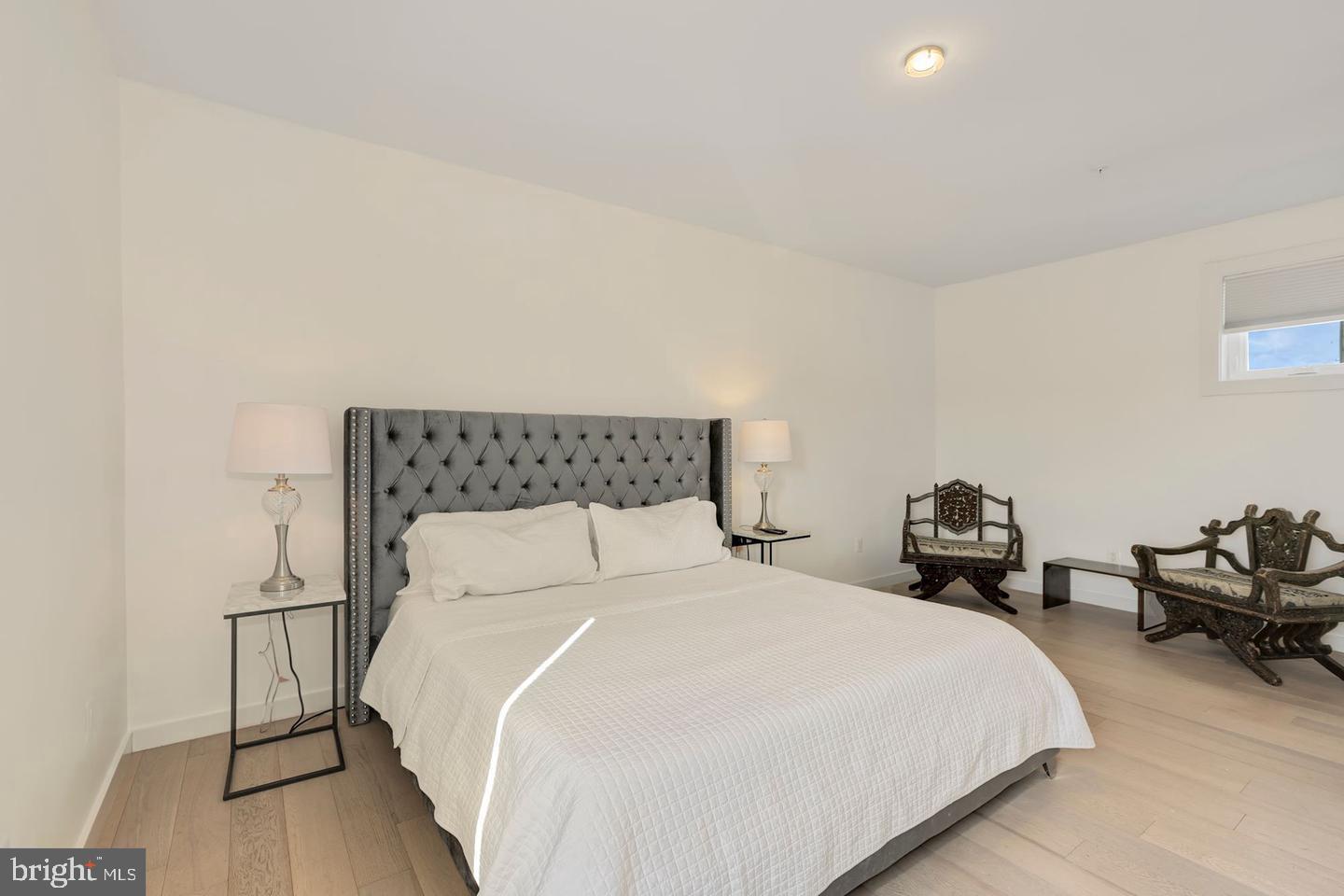 1495 Gallaudet Street Northeast Washington, DC 20002 - Photo 26 of 32 a bedroom with a bed and wooden floor