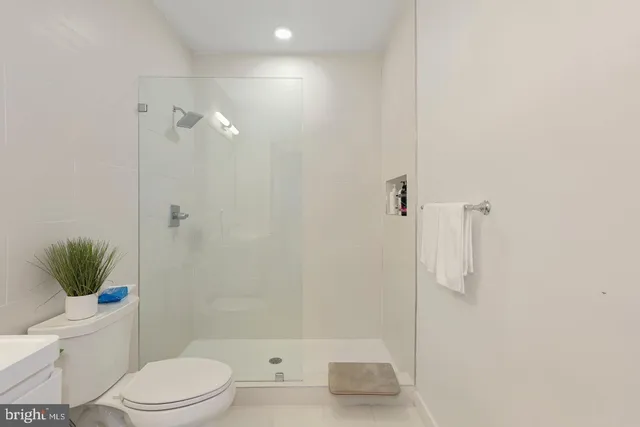 a bathroom with a toilet and a shower