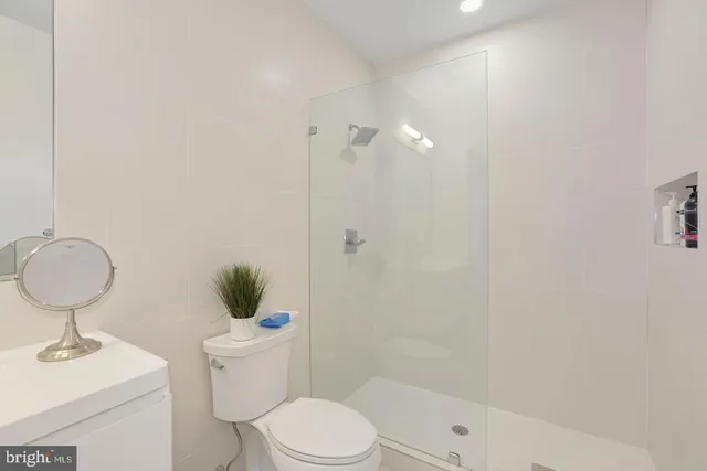 a bathroom with a toilet sink and shower