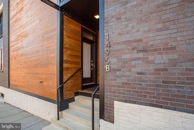 a view of front door of house with wooden floor