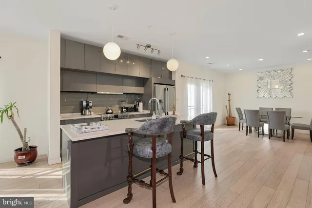 a kitchen with stainless steel appliances granite countertop a sink and cabinets