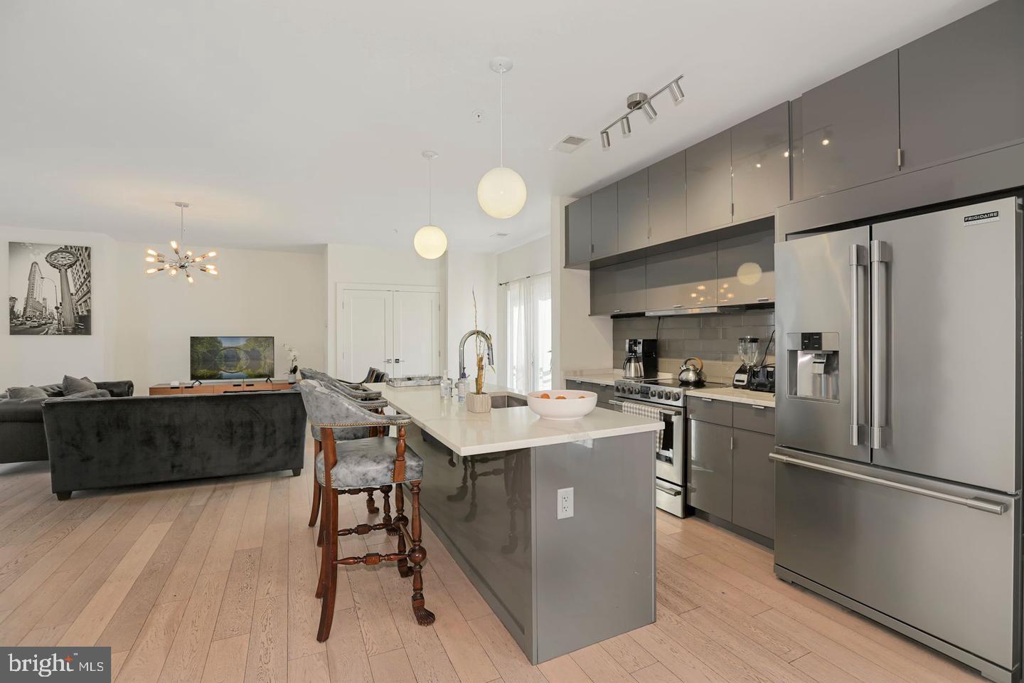 1495 Gallaudet Street Northeast Washington, DC 20002 - Photo 5 of 32 a kitchen with stainless steel appliances a sink a stove a refrigerator cabinets and a dining table