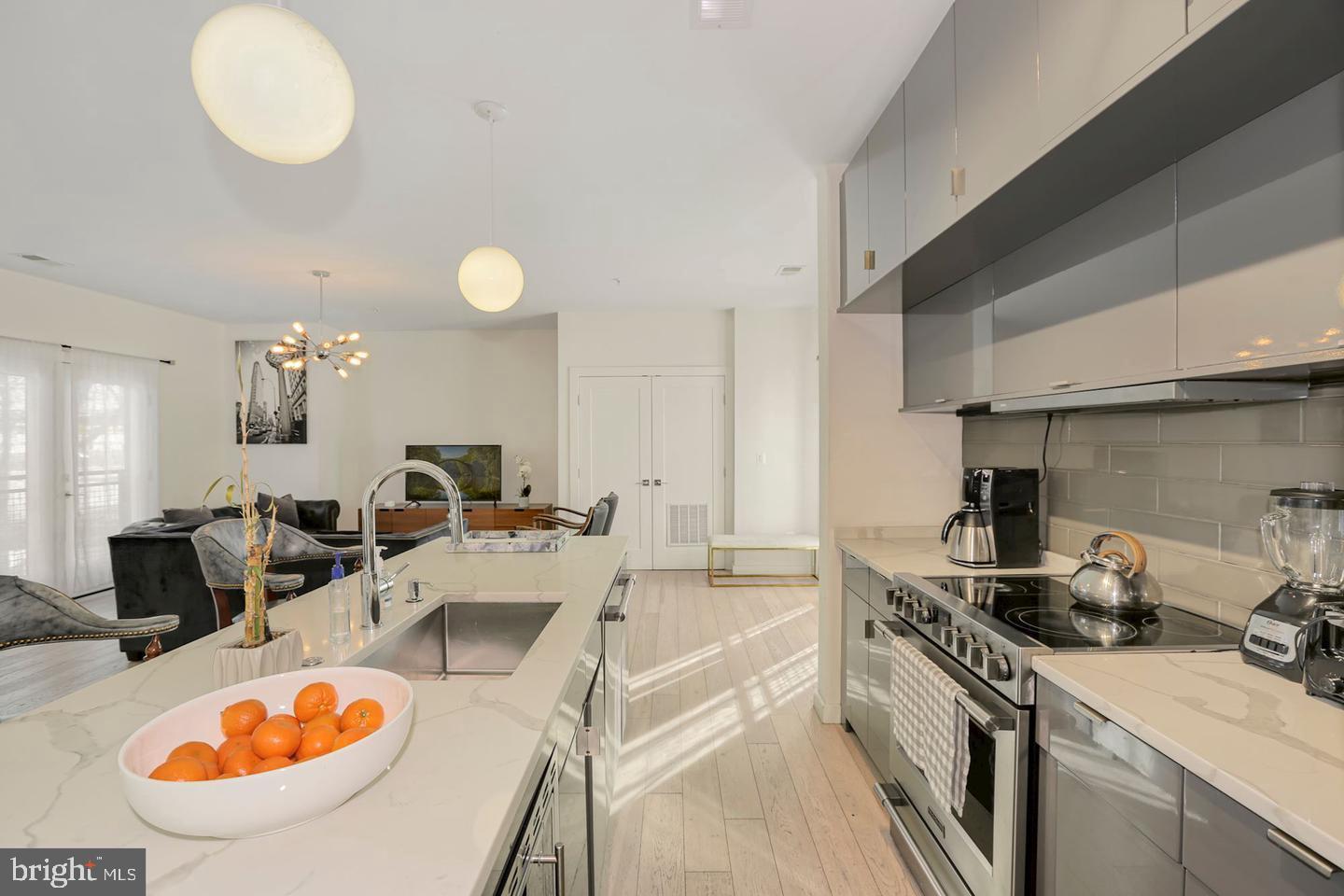 1495 Gallaudet Street Northeast Washington, DC 20002 - Photo 6 of 32 a kitchen with stainless steel appliances granite countertop a sink a stove and a wooden floors