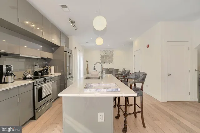 a kitchen with a table chairs sink and cabinets