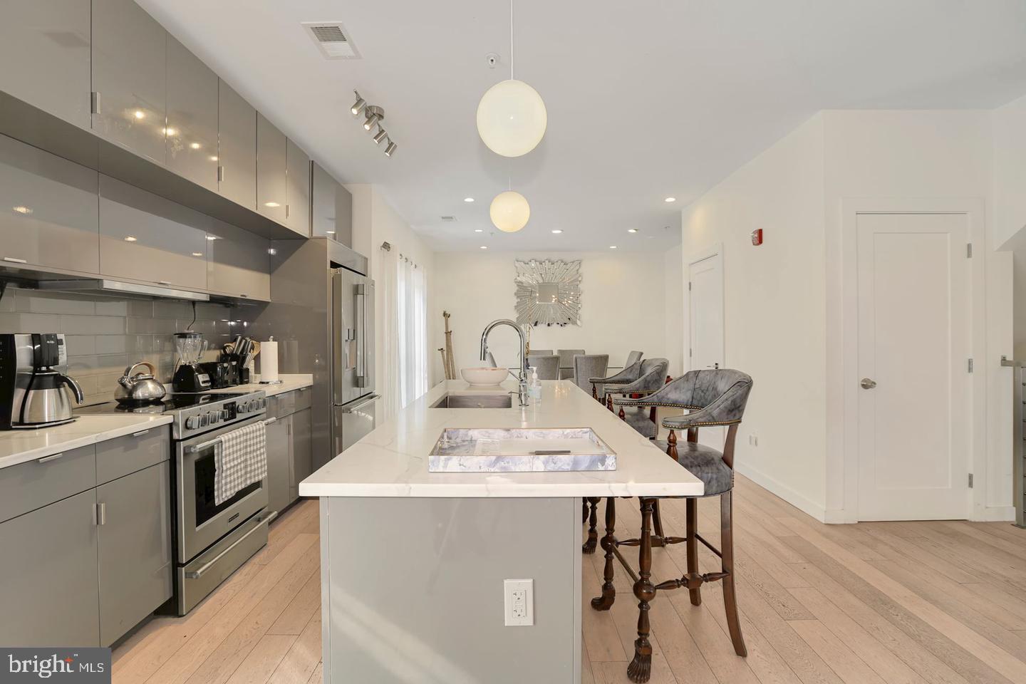1495 Gallaudet Street Northeast Washington, DC 20002 - Photo 7 of 32 a kitchen with a table chairs sink and cabinets