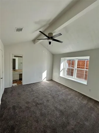 a view of a livingroom with a ceiling fan and window