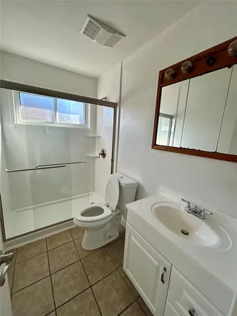 a bathroom with a toilet a sink and shower