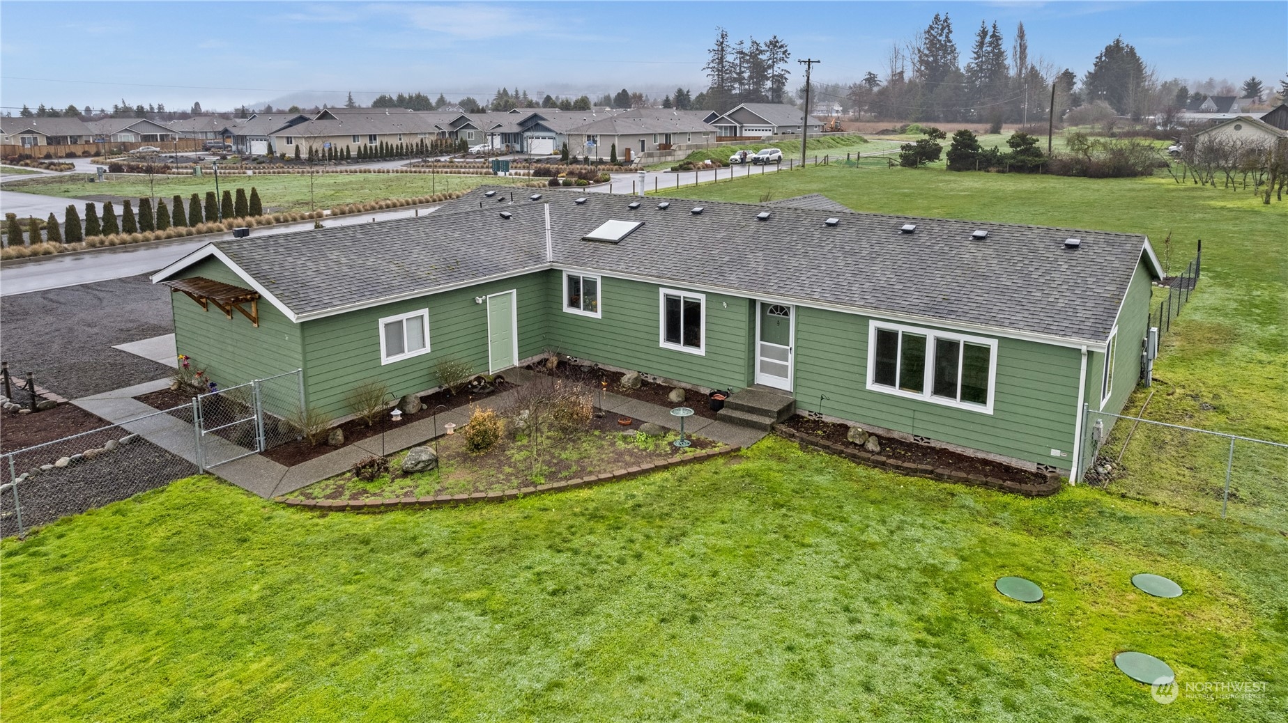 901 West Hendrickson Road Sequim, WA 98382 - Photo 1 of 39 an aerial view of a house with a yard and lake view