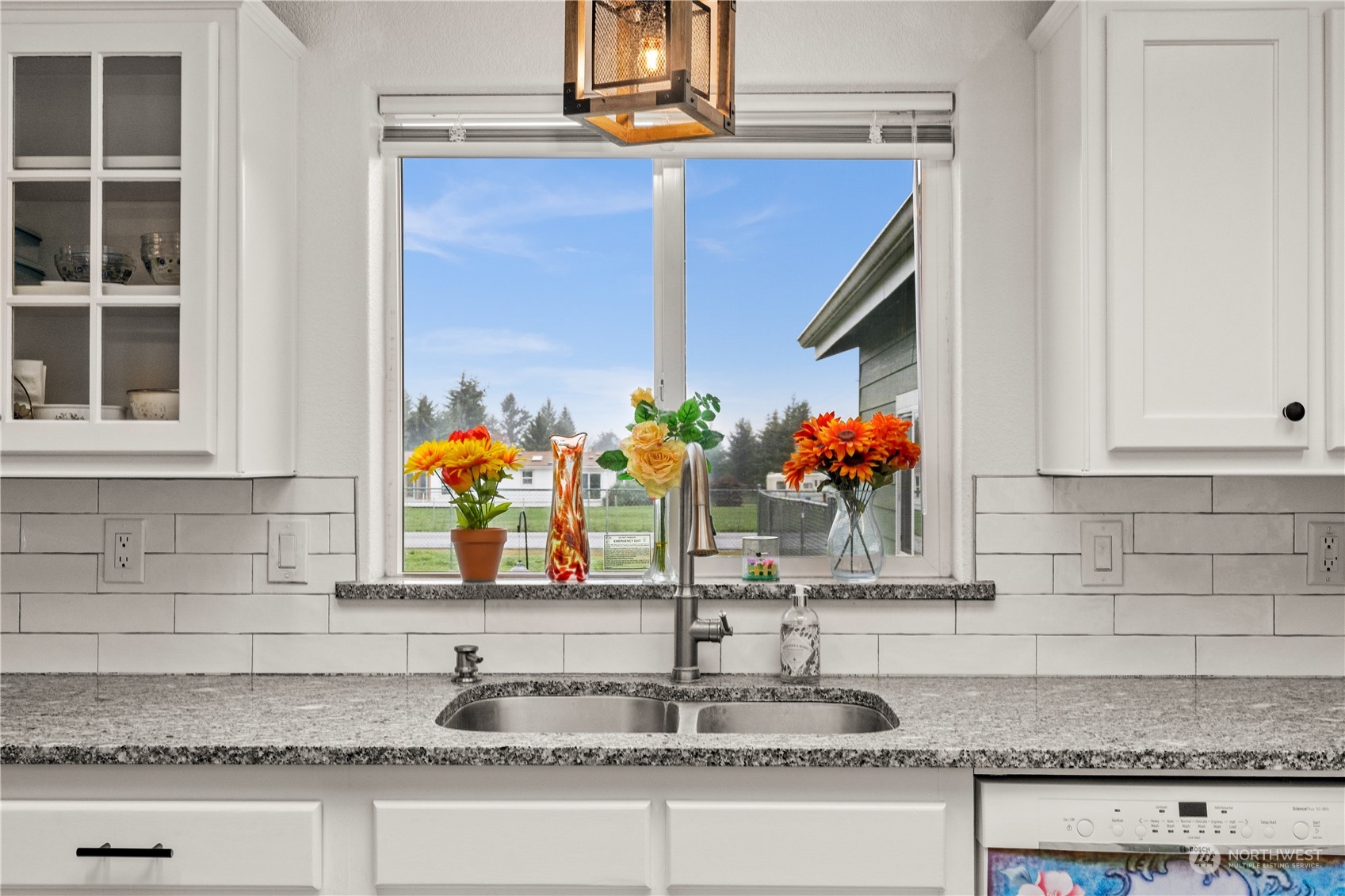 901 West Hendrickson Road Sequim, WA 98382 - Photo 16 of 39 a kitchen sink with granite countertop granite countertop a sink a stove and cabinets