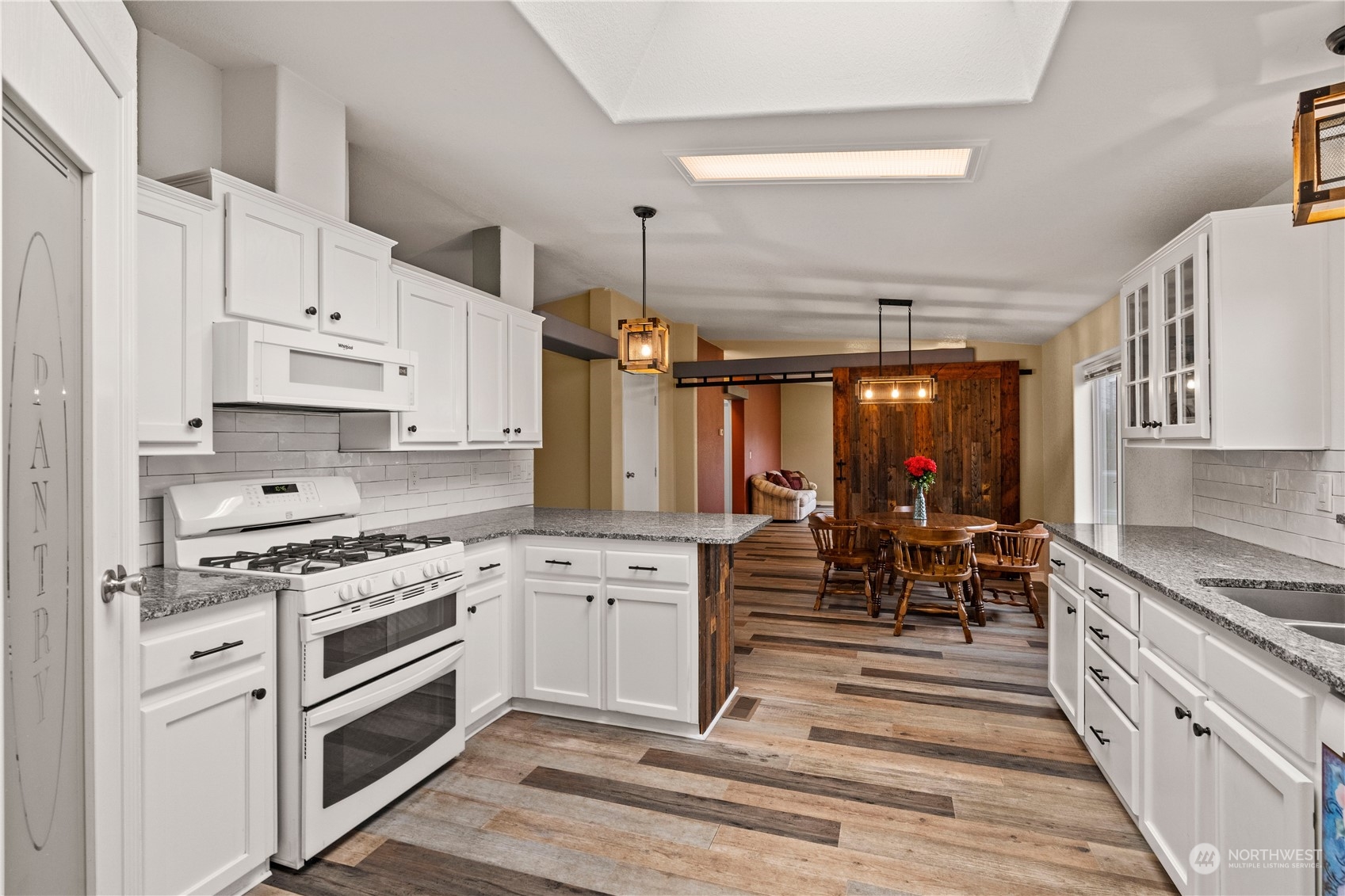 901 West Hendrickson Road Sequim, WA 98382 - Photo 17 of 39 a kitchen with white cabinets and appliances