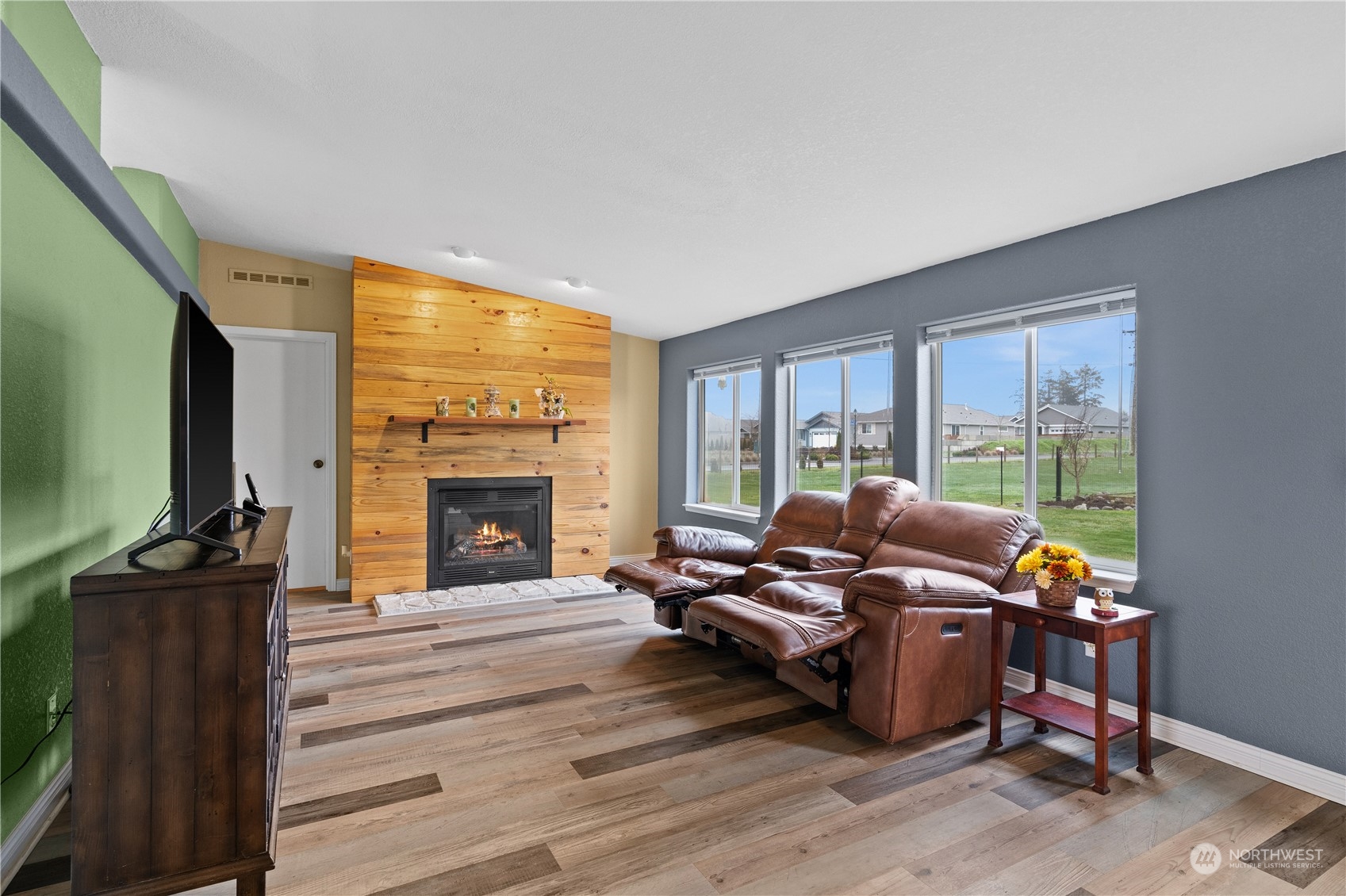 901 West Hendrickson Road Sequim, WA 98382 - Photo 21 of 39 a living room with furniture a fireplace and a flat screen tv
