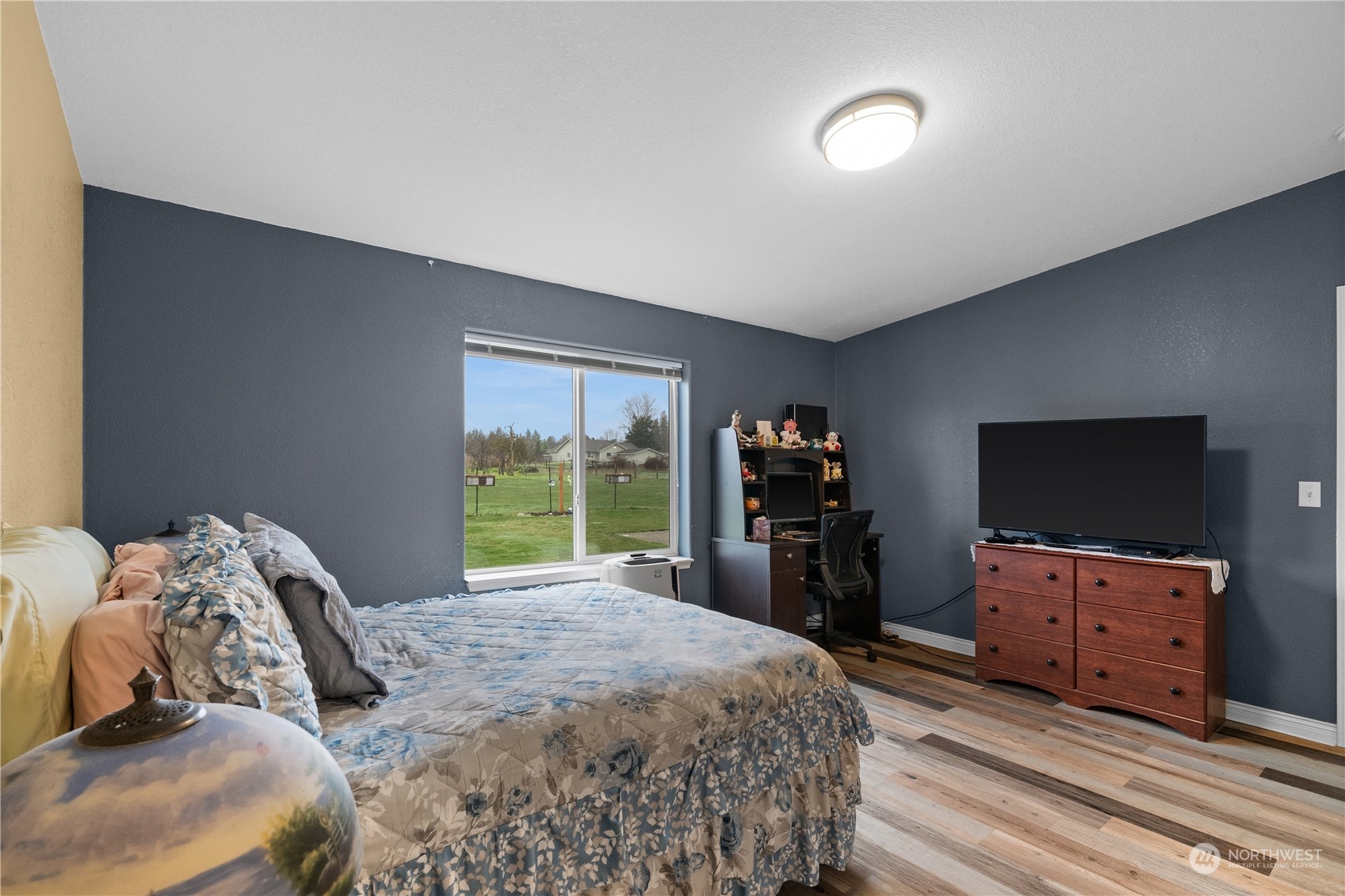 901 West Hendrickson Road Sequim, WA 98382 - Photo 24 of 39 a bedroom with bed and flat tv screen on dresser