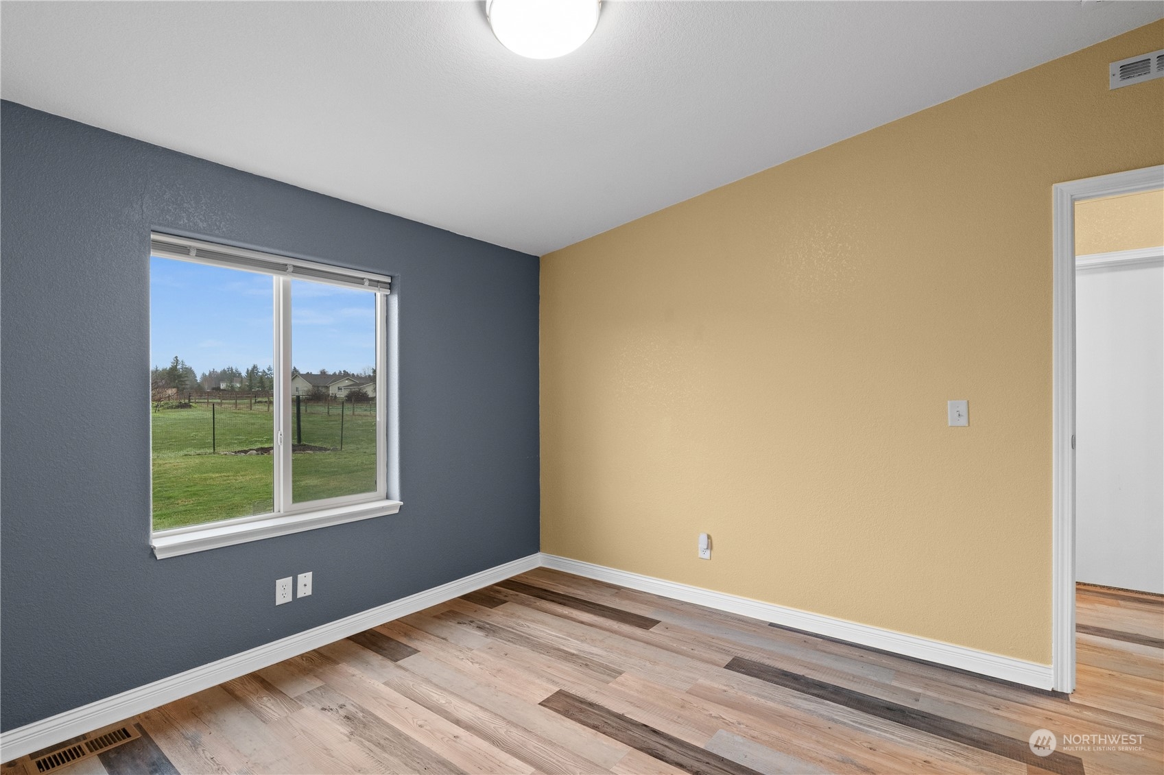 901 West Hendrickson Road Sequim, WA 98382 - Photo 29 of 39 a view of an empty room with wooden floor and a window