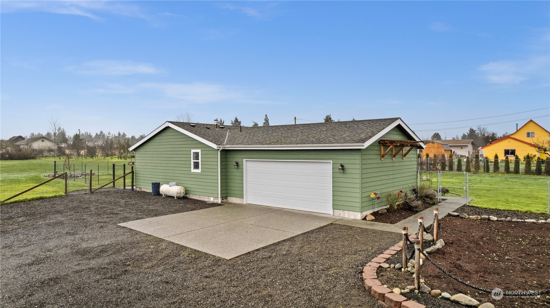 901 West Hendrickson Road Sequim, WA 98382 - Photo 3 of 39 a view of a house with backyard and a garden