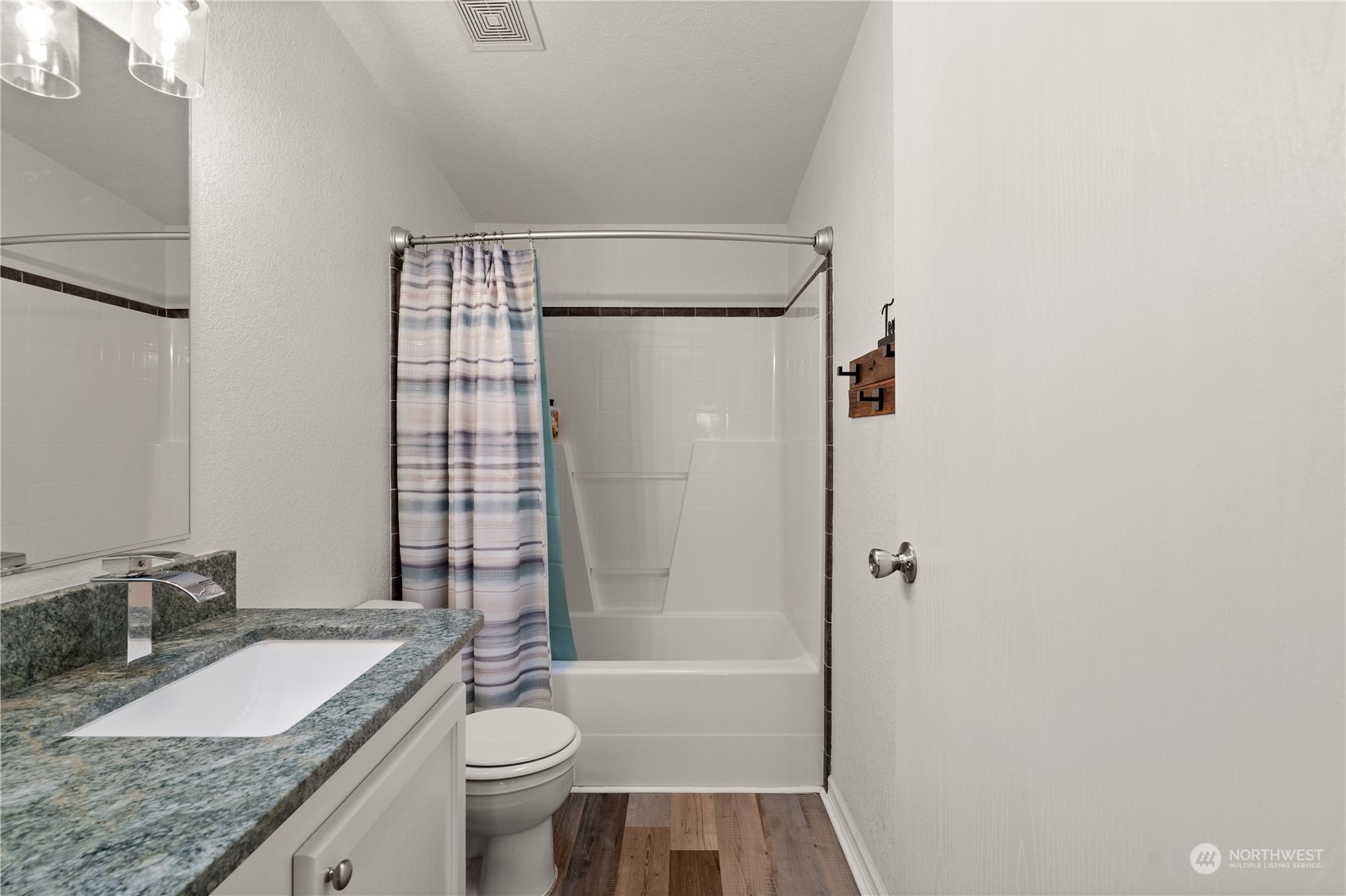 901 West Hendrickson Road Sequim, WA 98382 - Photo 31 of 39 a bathroom with a granite countertop sink toilet and shower