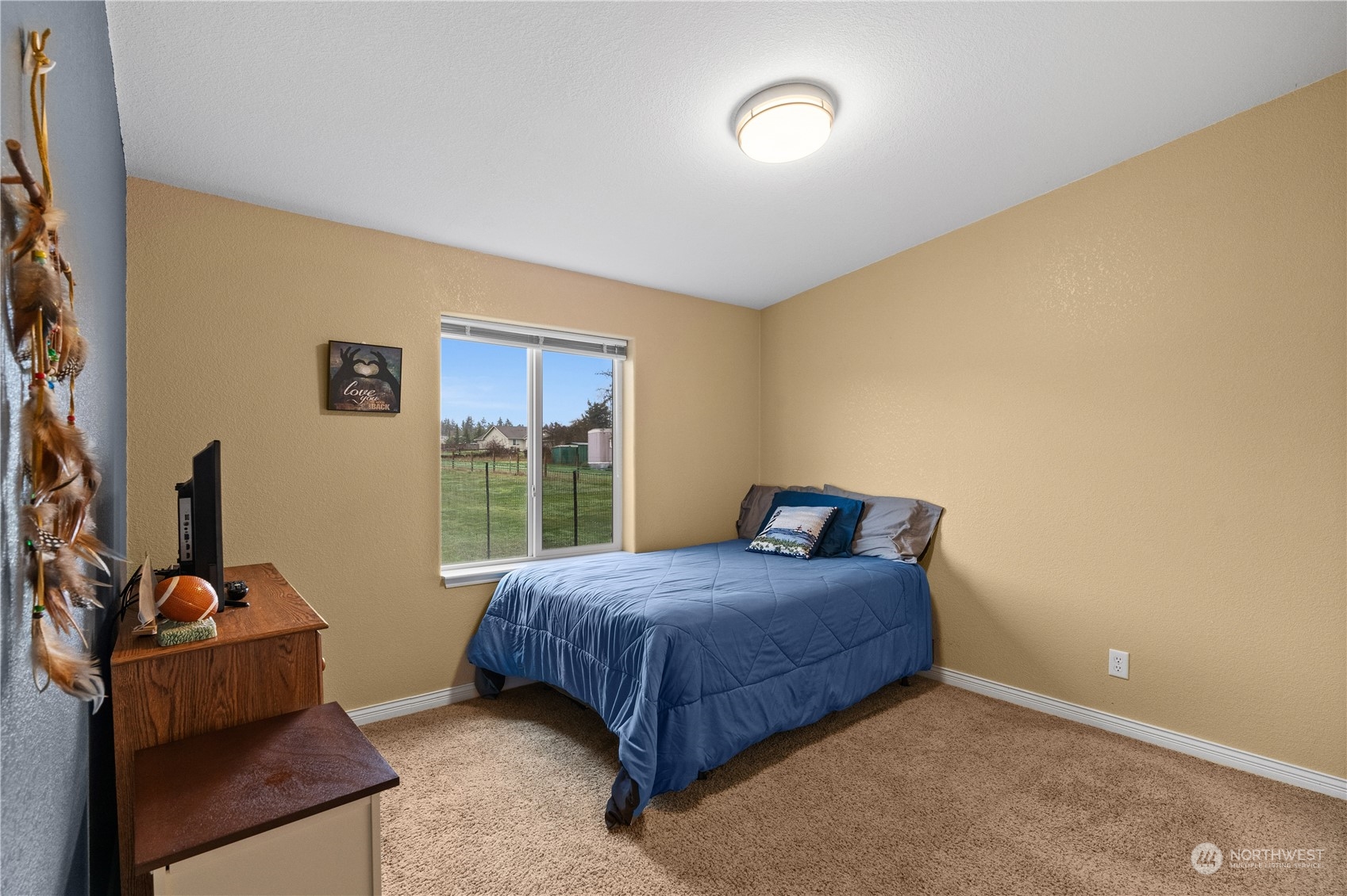 901 West Hendrickson Road Sequim, WA 98382 - Photo 32 of 39 a bedroom with a bed and a window
