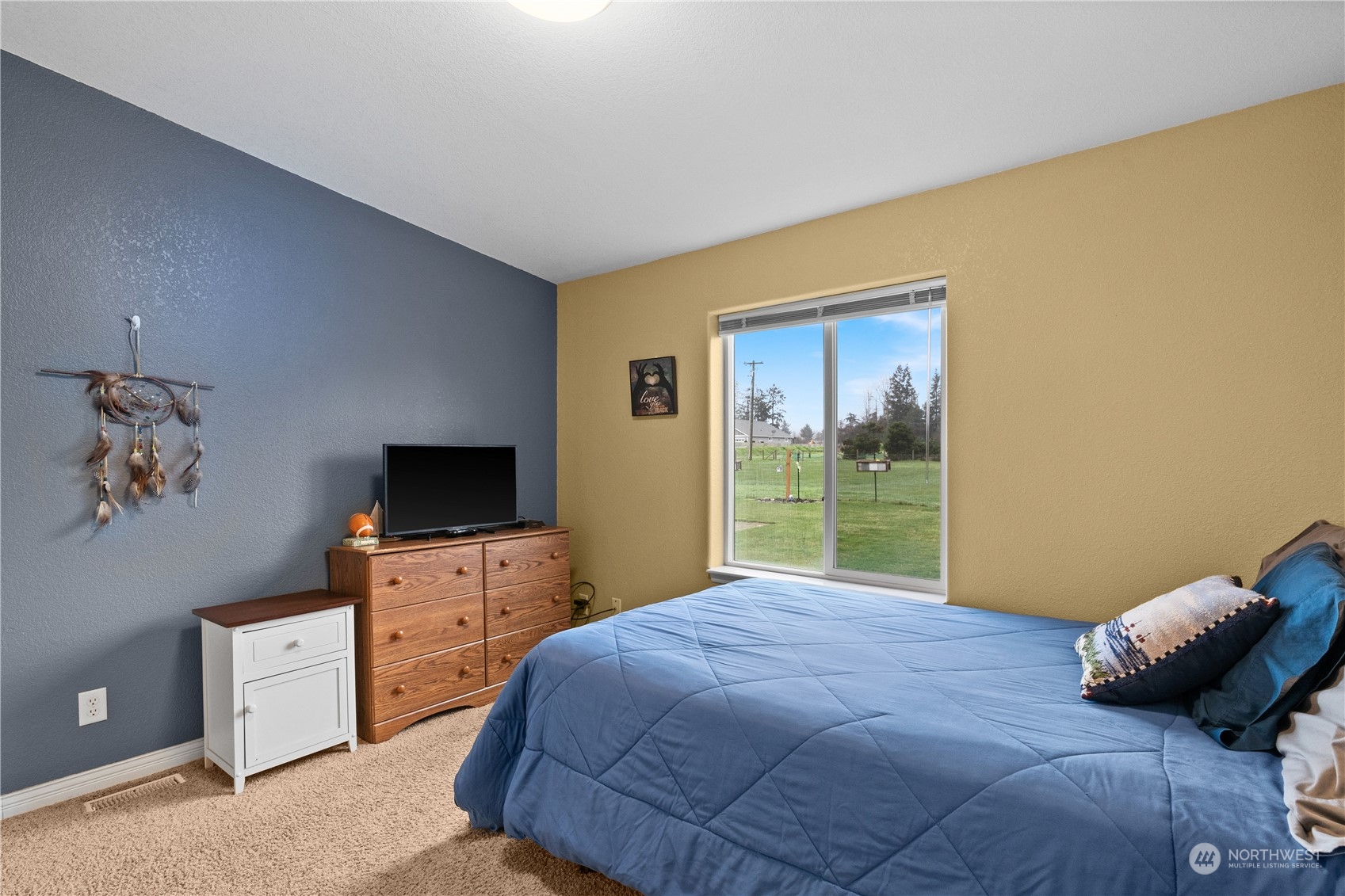 901 West Hendrickson Road Sequim, WA 98382 - Photo 33 of 39 a bedroom with a bed and a television