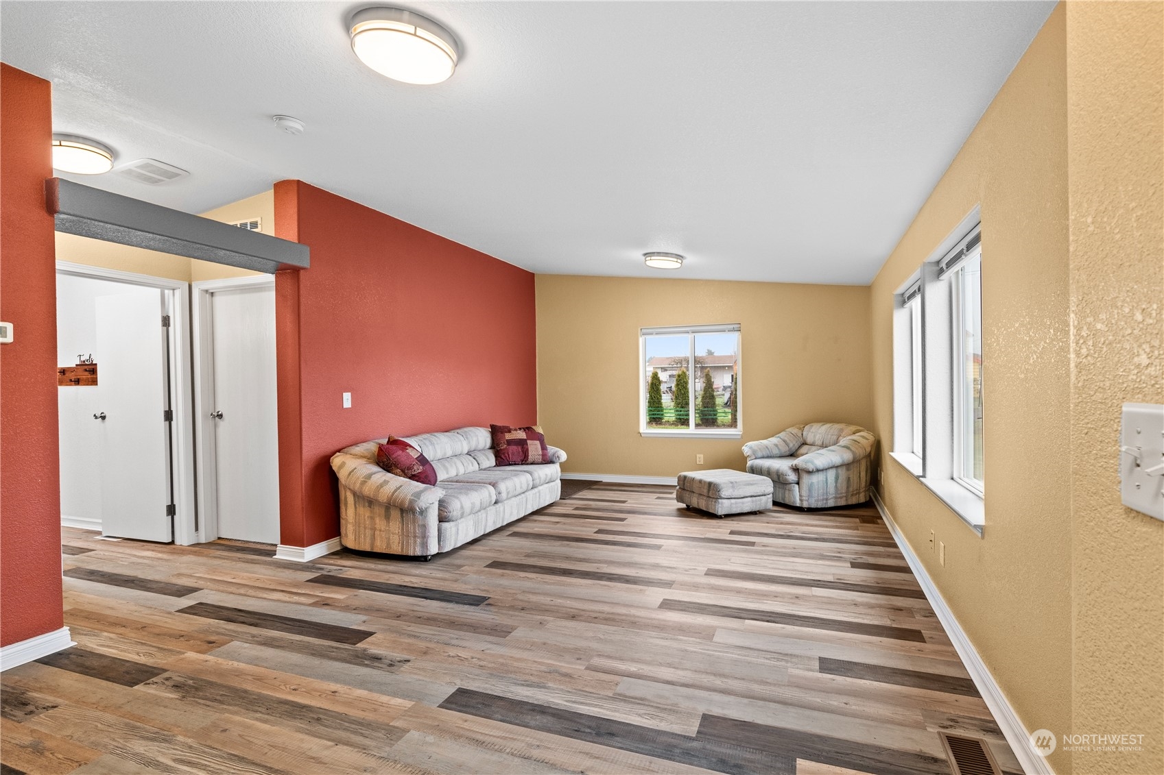 901 West Hendrickson Road Sequim, WA 98382 - Photo 7 of 39 a bedroom with a bed and wooden floor