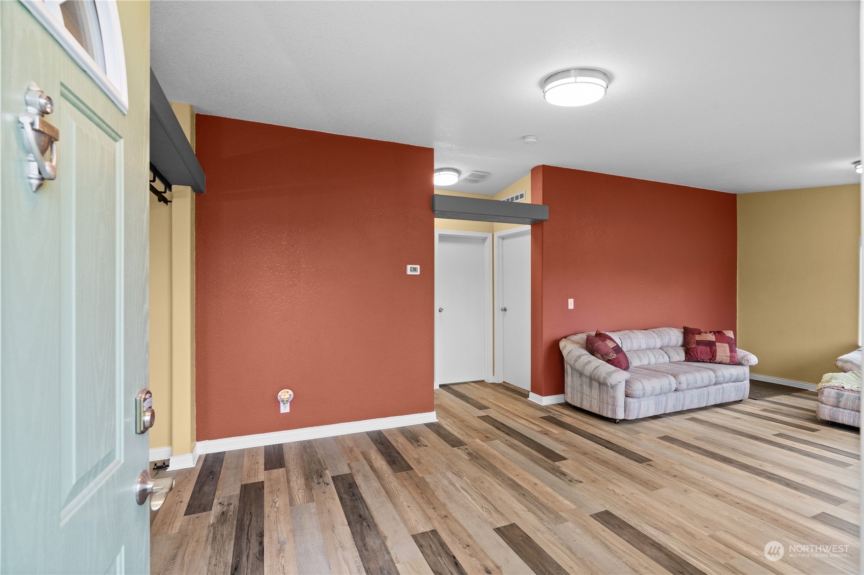 901 West Hendrickson Road Sequim, WA 98382 - Photo 9 of 39 a bedroom with a bed and wooden floor