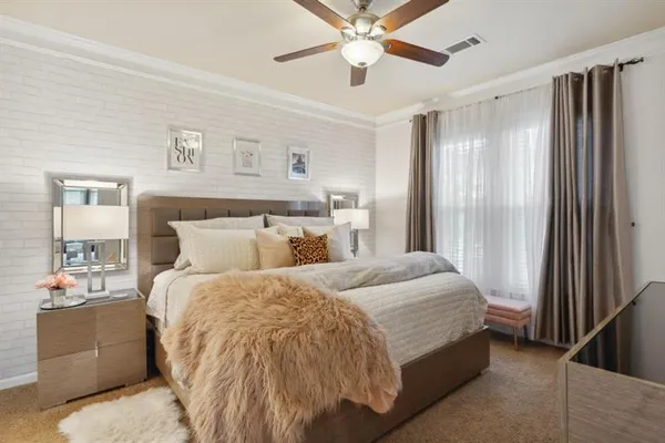 a bedroom with a large bed and a chandelier