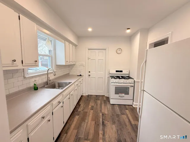 a kitchen with a white cabinets and white appliances