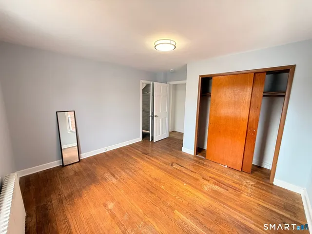 a view of a room with closet and wooden floor