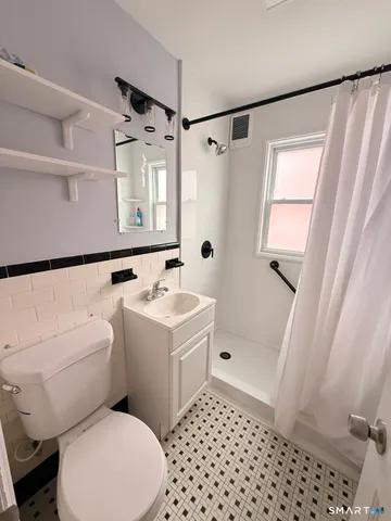 a bathroom with a sink toilet and shower